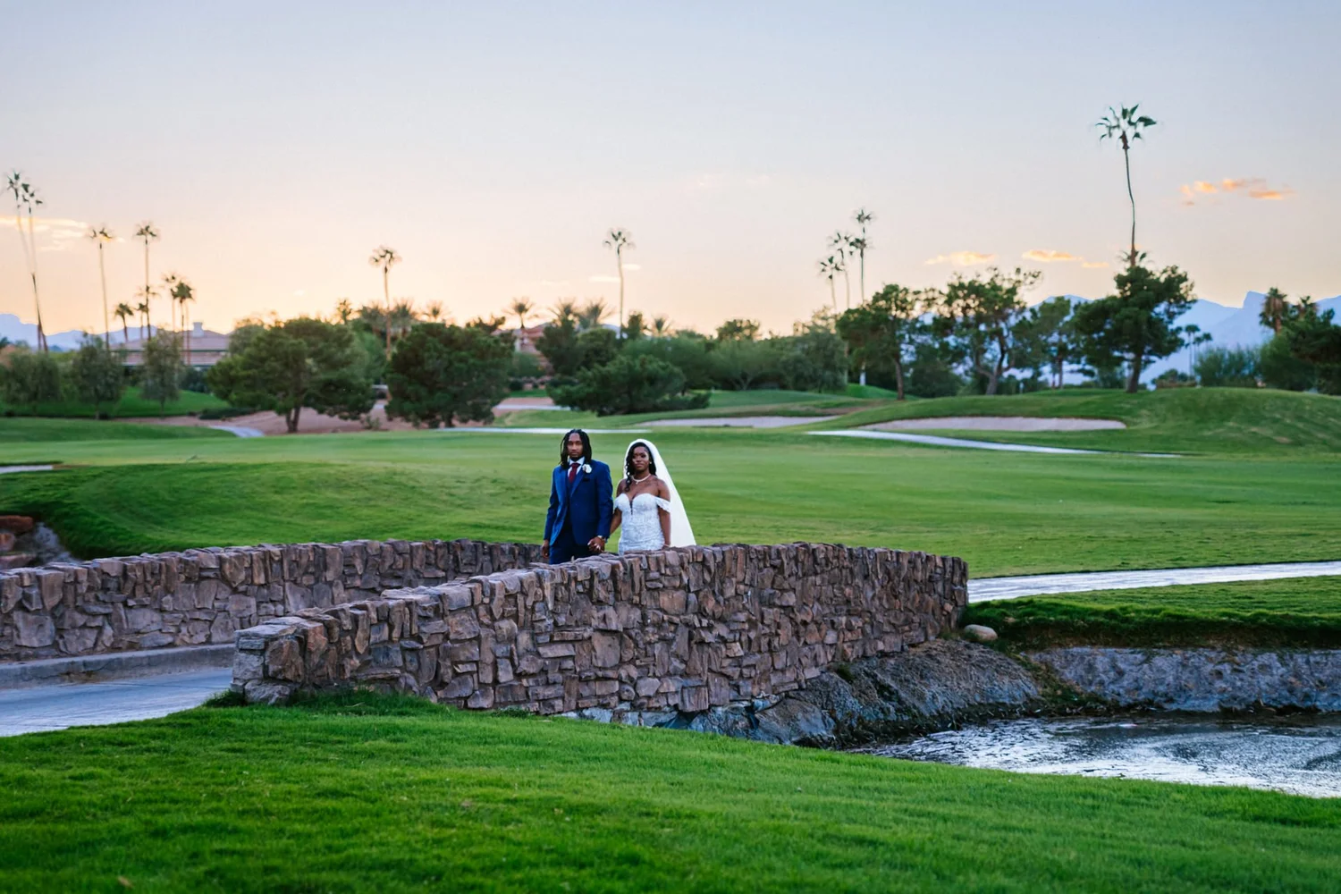 Las Vegas wedding photography — hand in hand on a stone bridge at sunset