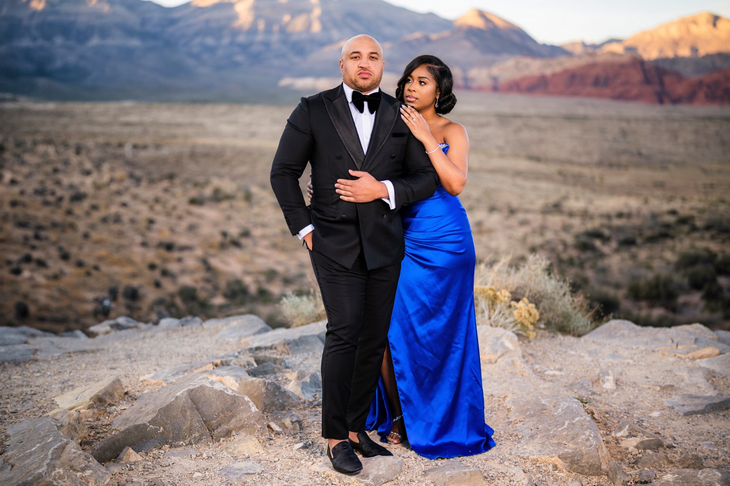 Las Vegas engagement photography — couple in formal attire at a desert overlook at golden hour