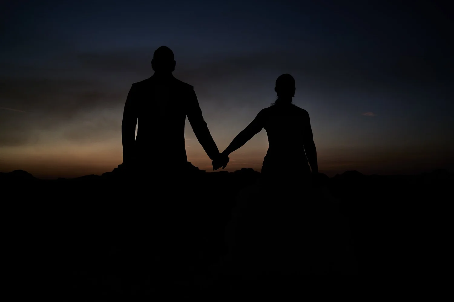 Las Vegas wedding photography — couple on a red rock formation at sunset